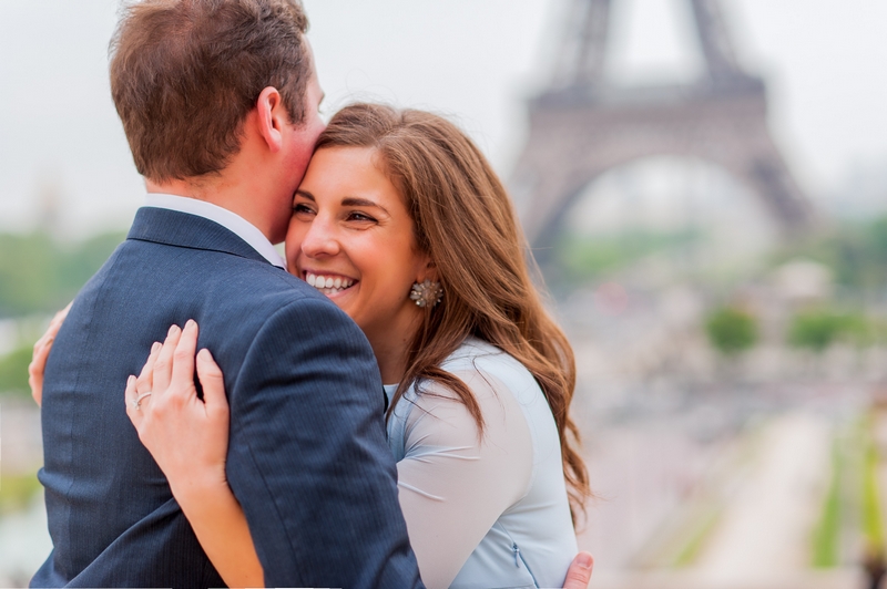 Engagement pictures in Paris couple hugging at Eiffel Tower