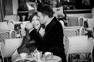 Couple enjoying croissants and hot chocolate in Parisian café
