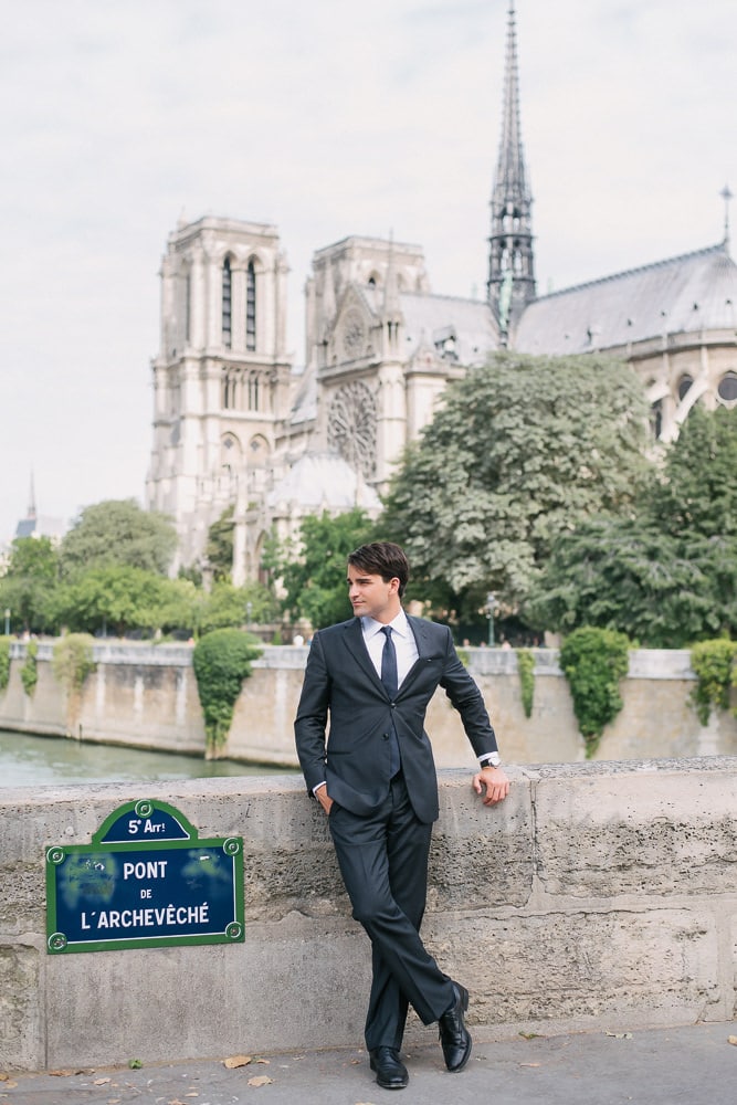 Portrait of a young man dressed elegantly in front of the Notre Dame cathedral Portrait of a young man dressed elegantly in front of the Notre Dame cathedral