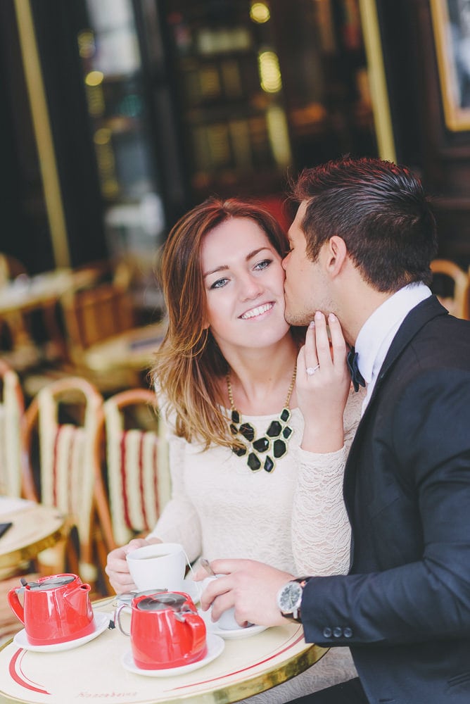 Young couple celebrating their Paris engagement in a typical Parisian cafe Young couple celebrating their Paris engagement in a typical Parisian cafe