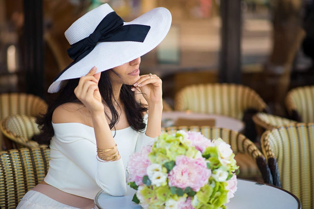 Beautiful brunette girl wearing white hat in a Parisian café Beautiful brunette girl wearing white hat in a Parisian café