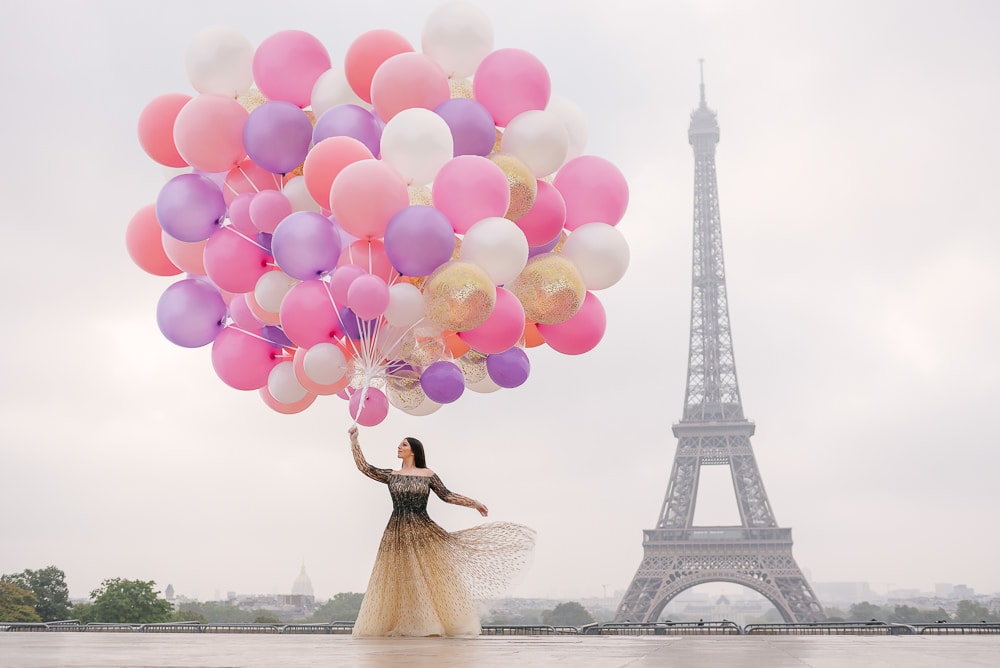 Bride with a huge bouquet of colorful balloons dancing in Paris Bride with a huge bouquet of colorful balloons dancing in Paris