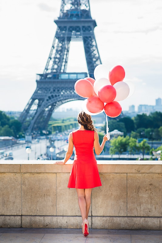 Beautiful woman in red dress with red balloons and red soles Beautiful woman in red dress with red balloons and red soles