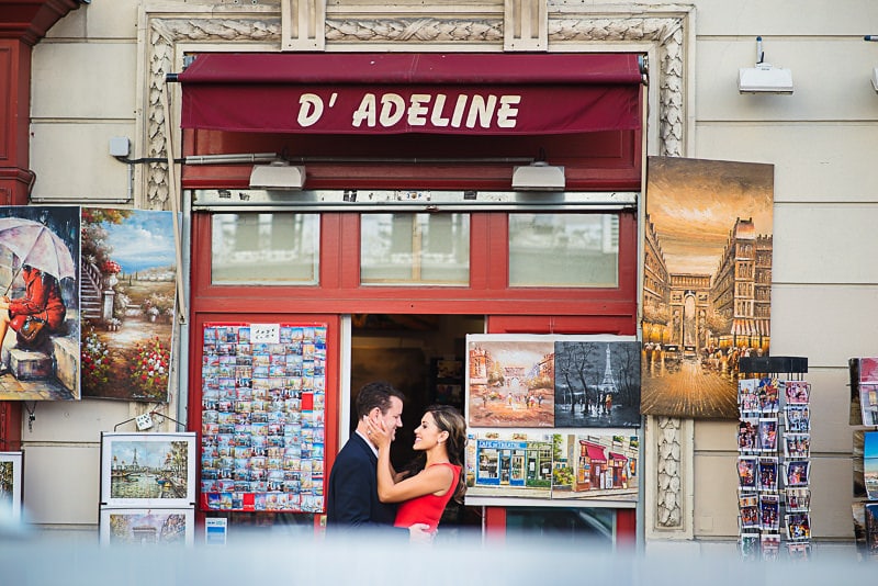 Couple kissing in front of souvenir shop at Montmartre Couple kissing in front of souvenir shop at Montmartre