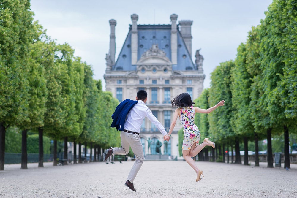 Photo shoot outfits that look nice for fun pictures in Paris Couple jumping in the air in their fun photoshoot outfit
