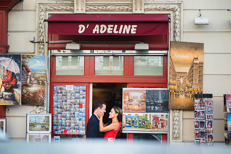 Couple kissing in front of souvenir shop at Montmartre
