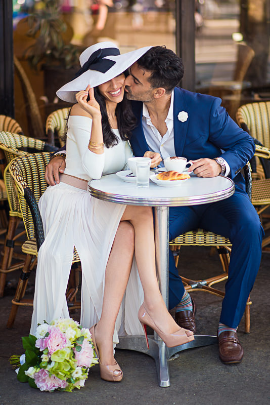 Kiss under the hat in a Parisian café
