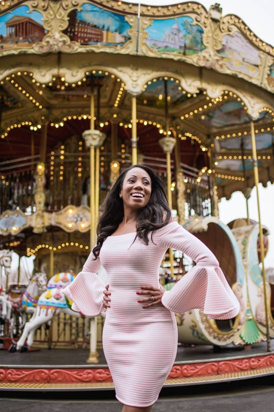 Beautiful black girl dressed in pink smiling in Paris
